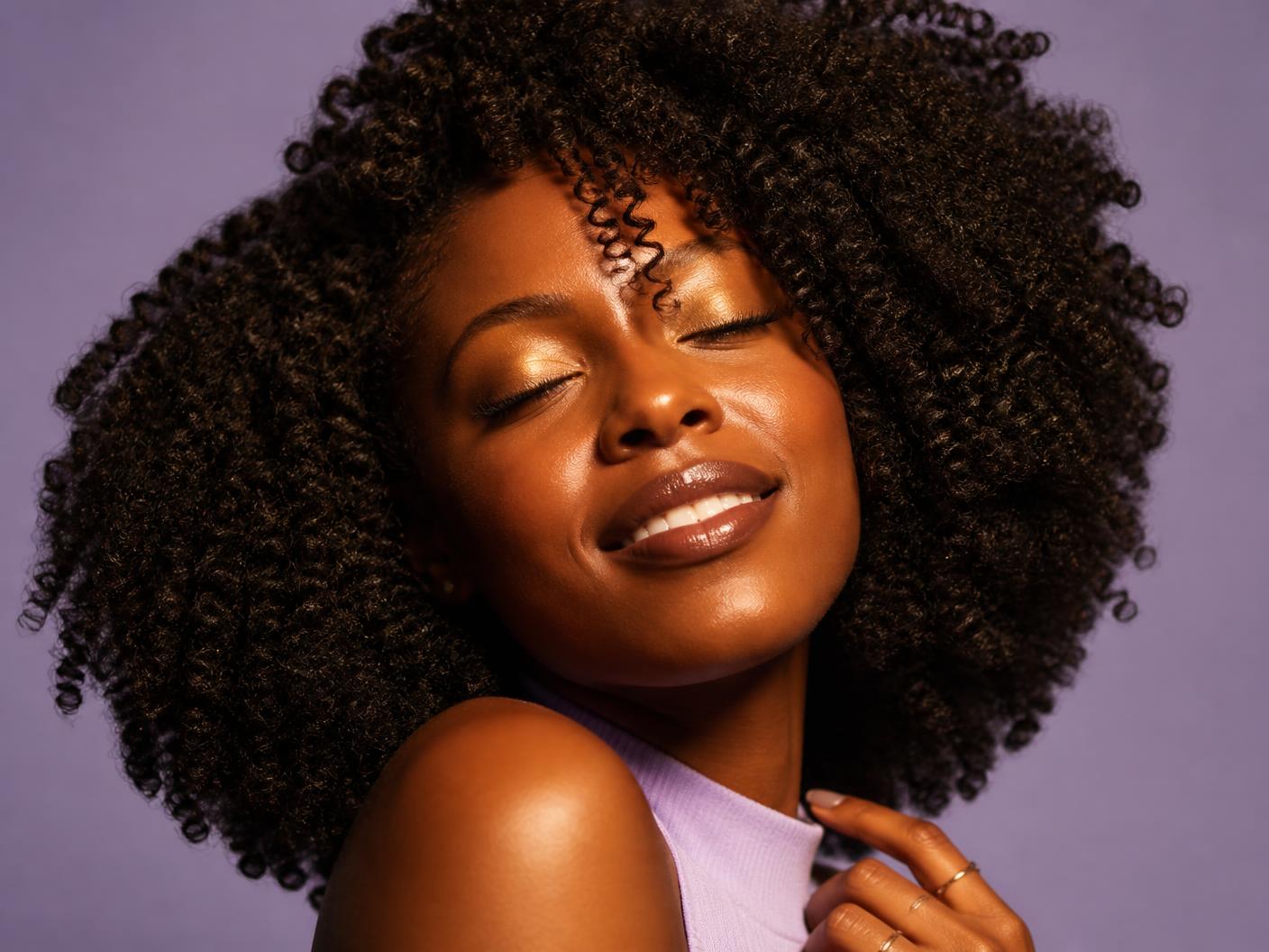 Seriri hair care — glowing natural coils on a lavender backdrop